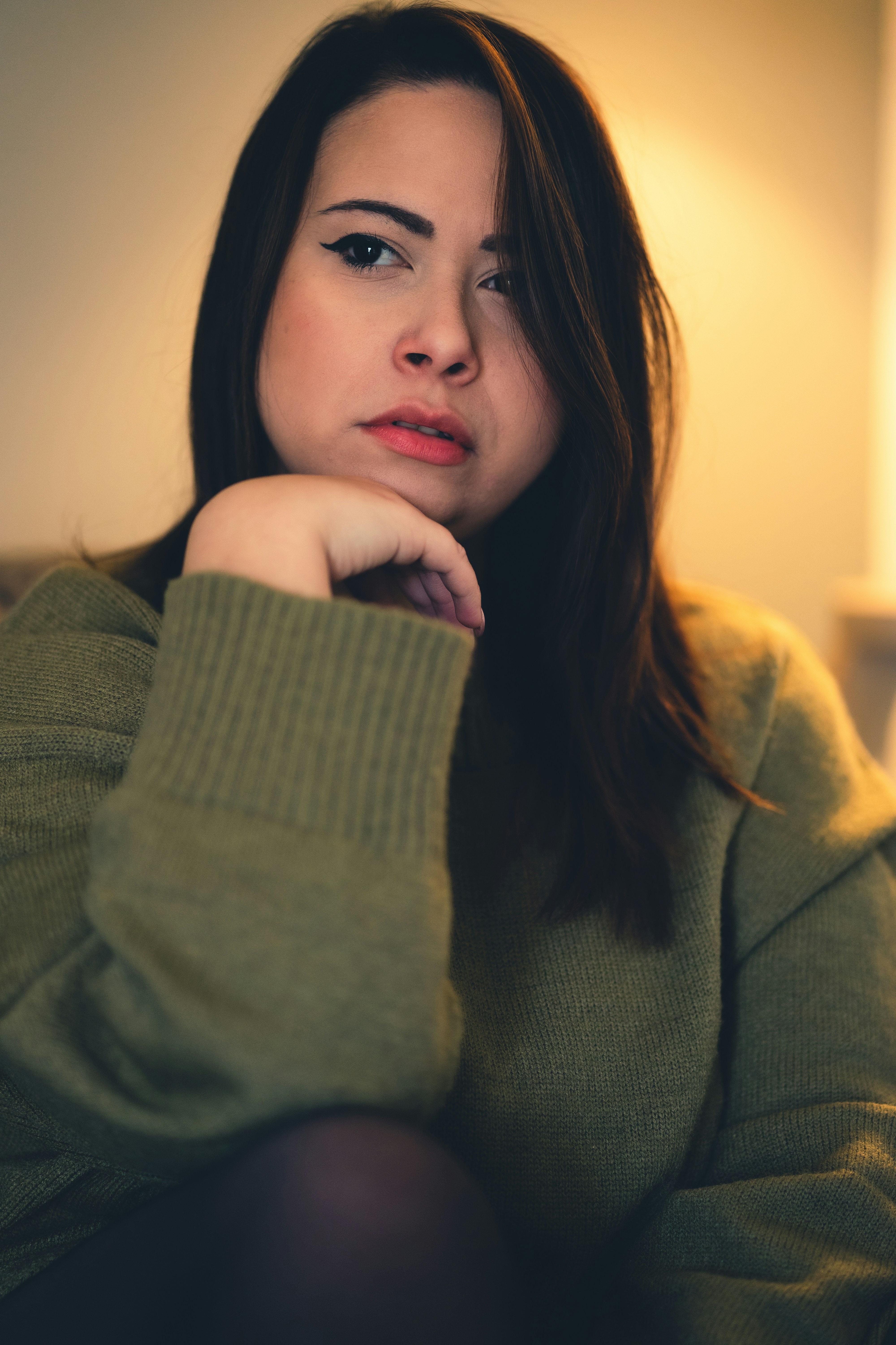 Thoughtful woman in green sweater